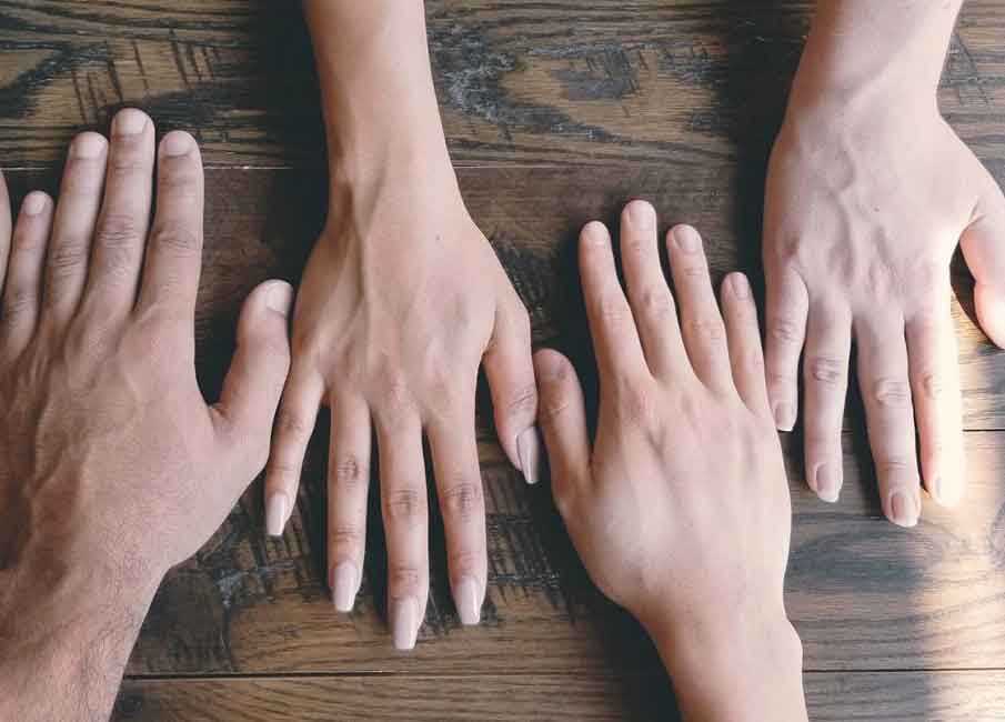 A photo of hands on a table.